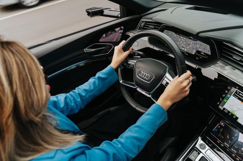 WOMAN DRIVING A NEW AUDI CAR