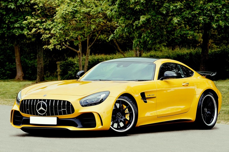 YELLOW MERCEDES-BENZ BESIDE TREES