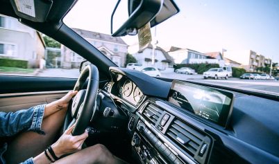 ANONYMOUS WOMAN DRIVING CAR IN TOWN