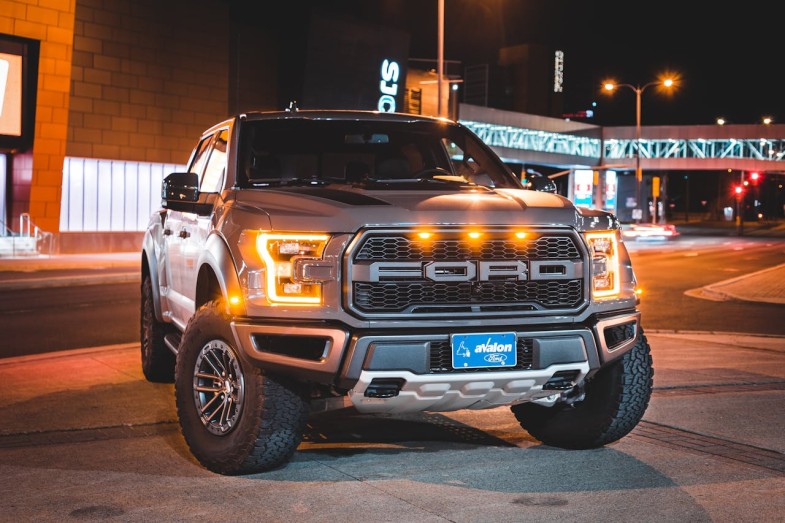 FORD CAR PARKED ON CITY STREET AT NIGHT