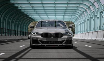 GRAY CAR PARKED AT A BRIDGE