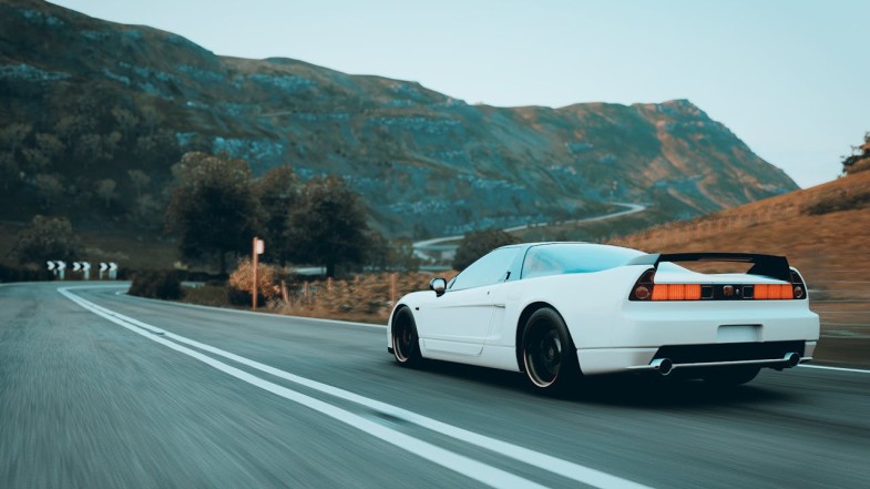 WHITE SPORTS CAR ON THE ROAD HONDA
