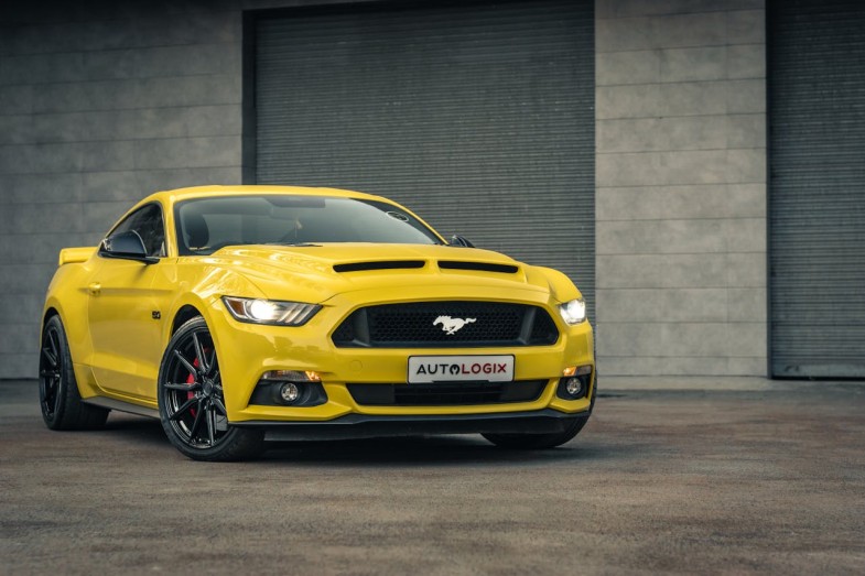 YELLOW FORD MUSTANG PARKED ON THE DRIVEWAY