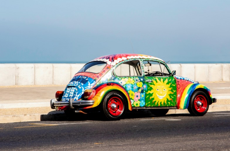MULTICOLORED VOLKSWAGEN BEETLE ON ROAD
