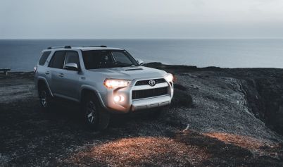 A TOYOTA 4 RUNNER PARKED ON THE SHORE