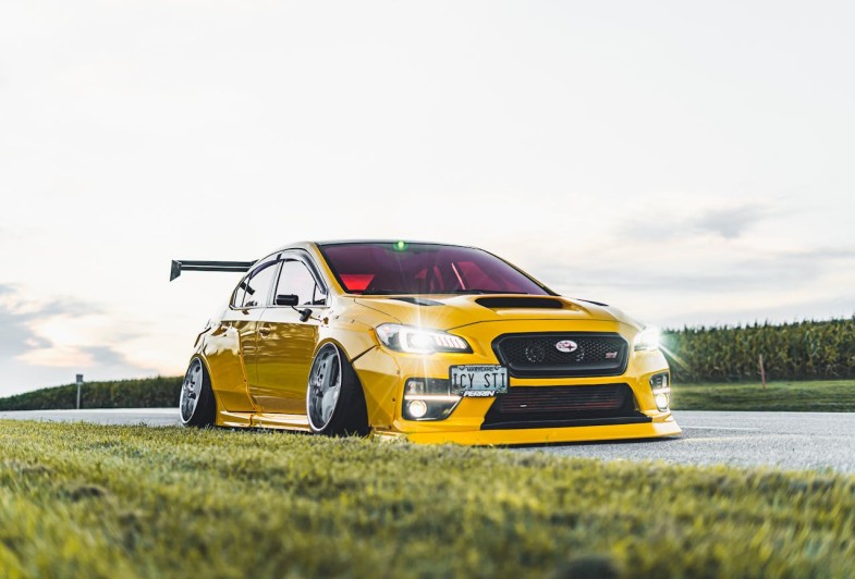 YELLOW SUBARU ON THE ROAD