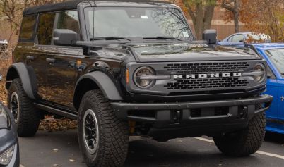 A BLACK VEHICLE PARKED FORD BRONCO