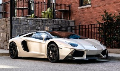 WHITE LAMBORGHINI PARKED ON THE ROAD