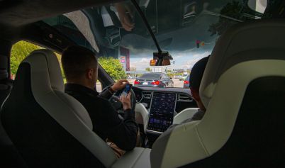 MAN DRIVING A TESLA