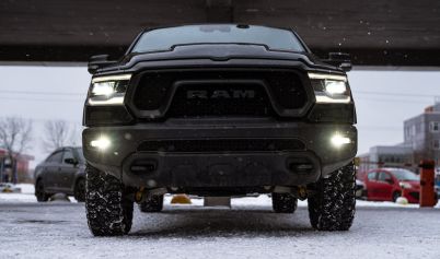 LOW ANGLE SHOT OF A BLACK RAM PICKUP TRUCK ON A PARKING LOT