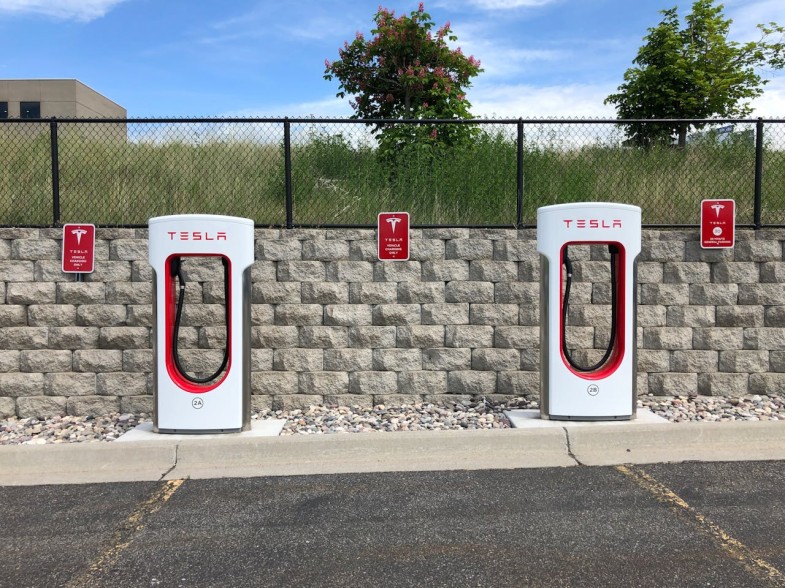 TWO WHITE AND RED TESLA CHARGING STATION