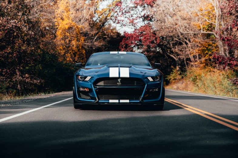 PHOTO OF BLUE MUSTANG ON ROAD FORD