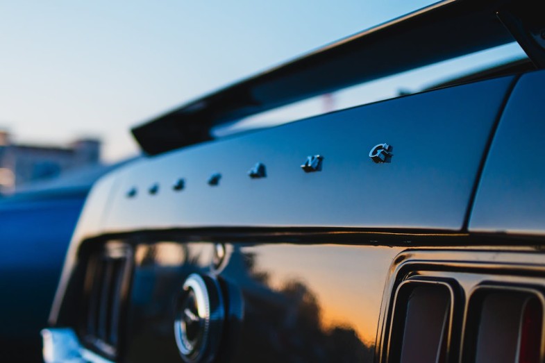CLOSE UP OF THE TRUNK OF A CLASSIC FORD MUSTANG