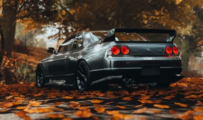 BACK VIEW OF A GRAY NISSAN SKYLINE