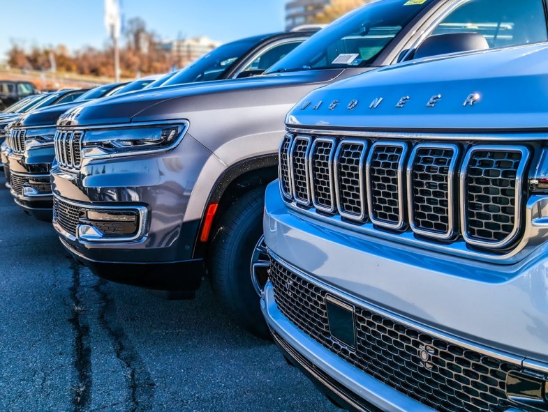 NEW JEEP WAGONEERS ON A PARKING LOT AT A CAR DEALERSHIP