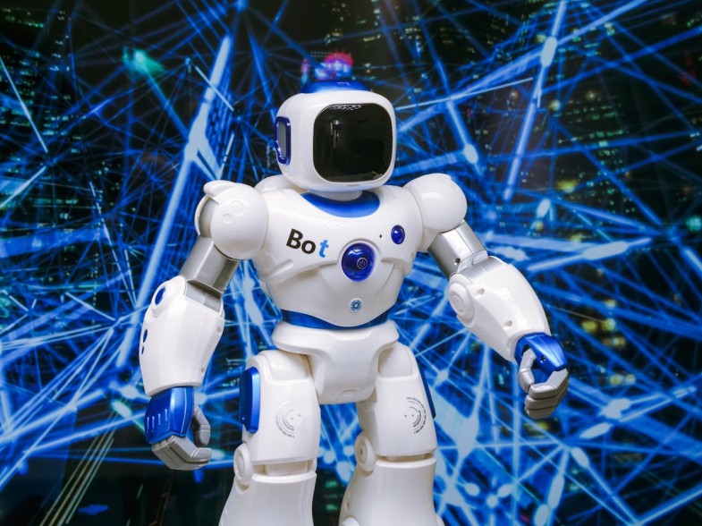 WHITE ROBOT ACTION FIGURE ON BLUE STRING LIGHTS