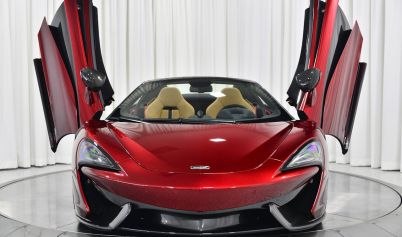 A BEAUTIFUL SHINY MCLAREN CAR WITH AN OPEN DOORS