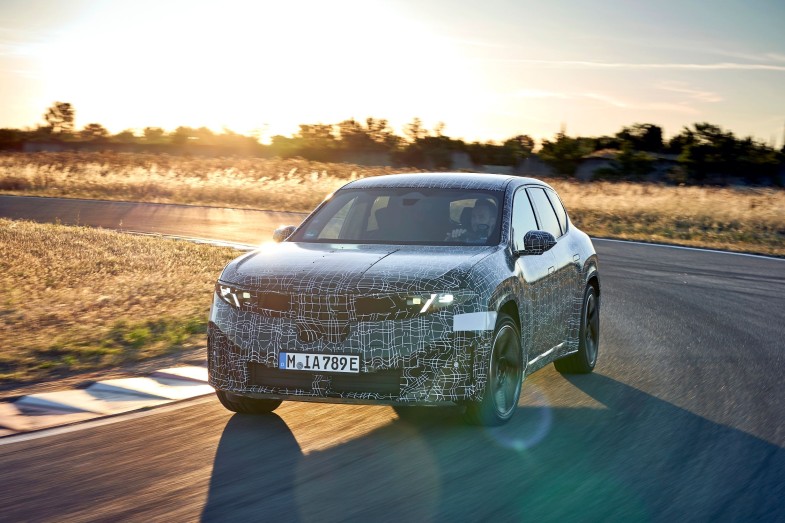 BMW iX3 prototype drives at sunset on test track