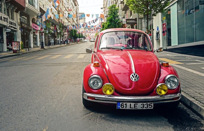 Red Beetle parked at the roadside near pedestrian lane