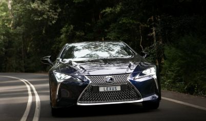 LEXUS CAR DRIVING ON FOREST ROAD