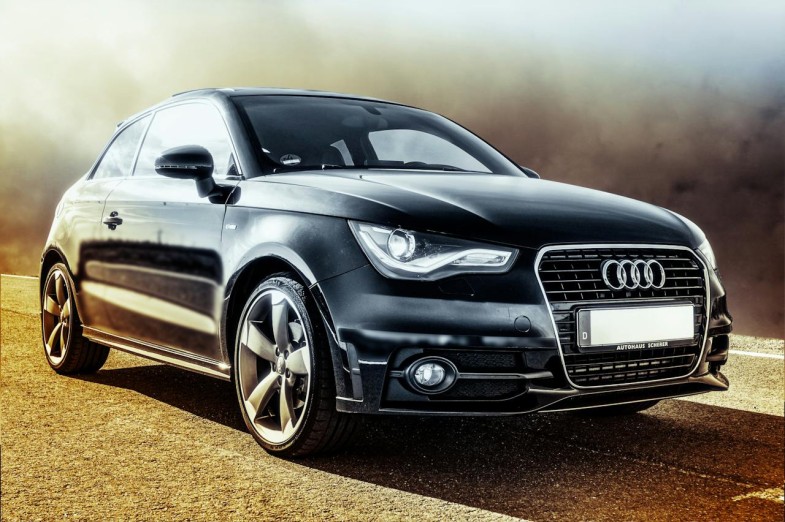 BLACK AUDI COUPE ON BROWN ROAD