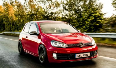 A VOLKSWAGEN GOLF ON THE ROAD