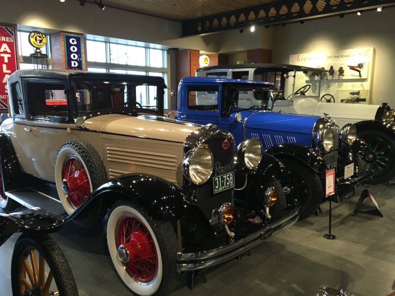 VINTAGE CARS IN A WELL-LIGHTED ROOM