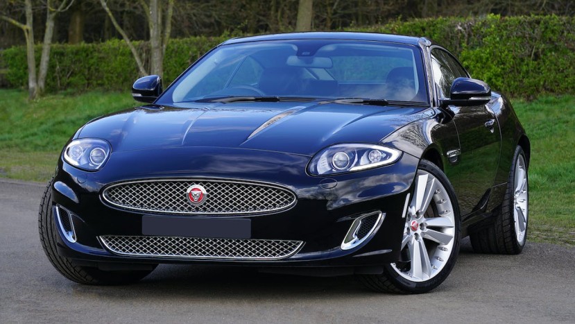 A BLACK JAGUAR PARKED ON THE ROADSIDE