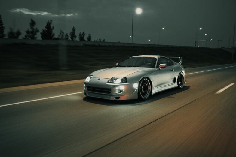 SILVER CAR ON THE ROAD