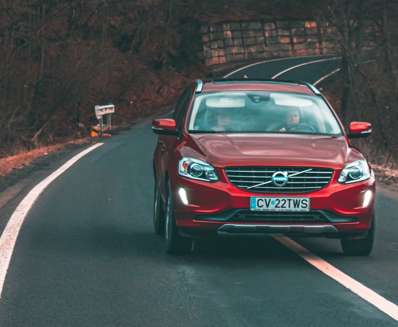RED MIDSIZE SUV CAR ON ROAD