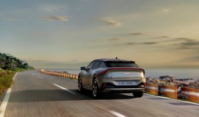 ELECTRIC VEHICLE DRIVING DOWN THE ROAD