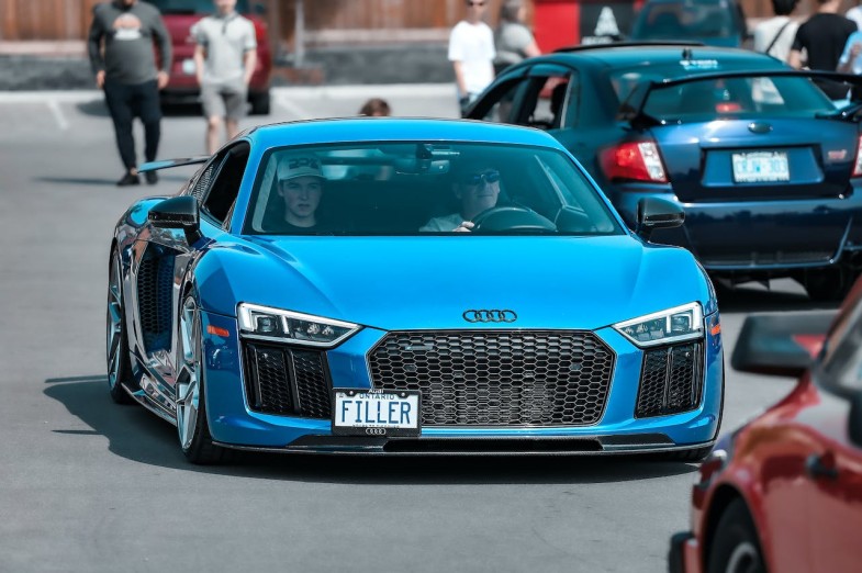MAN DRIVING BLUE AUDI R8 ON STREET