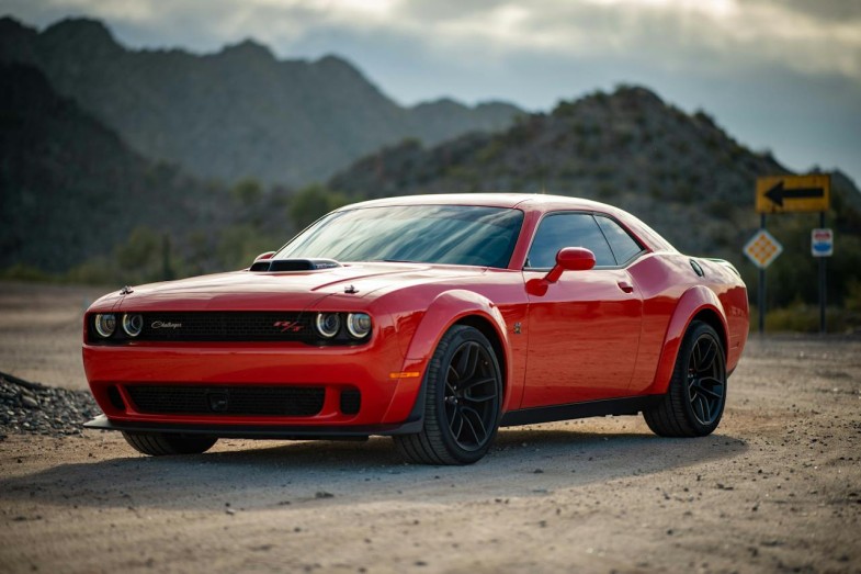 STELLANTIS, RED DODGE CHALLENGER PARKED ON UNPAVED ROAD