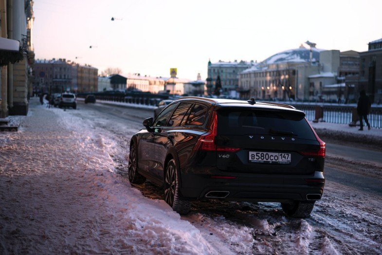CAR PARKED IN SNOW BY SIDEWALK
