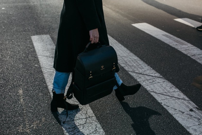 PERSONC CARRYING BAG WALKING ON PEDESTRIAN LANE