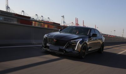 PHOTO OF A BLACK CADILLAC ON THE ROAD